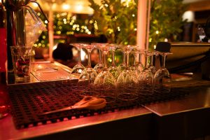 Polished glassware upturned on a bar counter