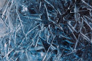 Dense frost crystals on a dark blue surface