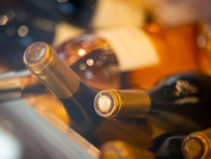 Wine bottle bases in a rack, lit from behind