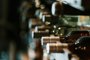 A row of wine bottles receding into shallow focus