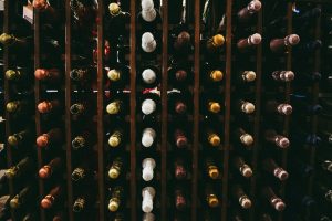 Wine bottles resting in a wooden storage rack
