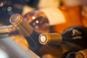 Wine bottles lying on their side in a cooling rack