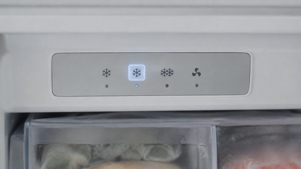 A close-up of a digital control panel on a built-in freezer unit showing a highlighted temperature mode setting